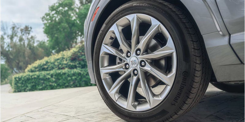 Close-up of the 2026 Buick Encore GX Preferred alloy wheel and front tire showcasing premium exterior styling.